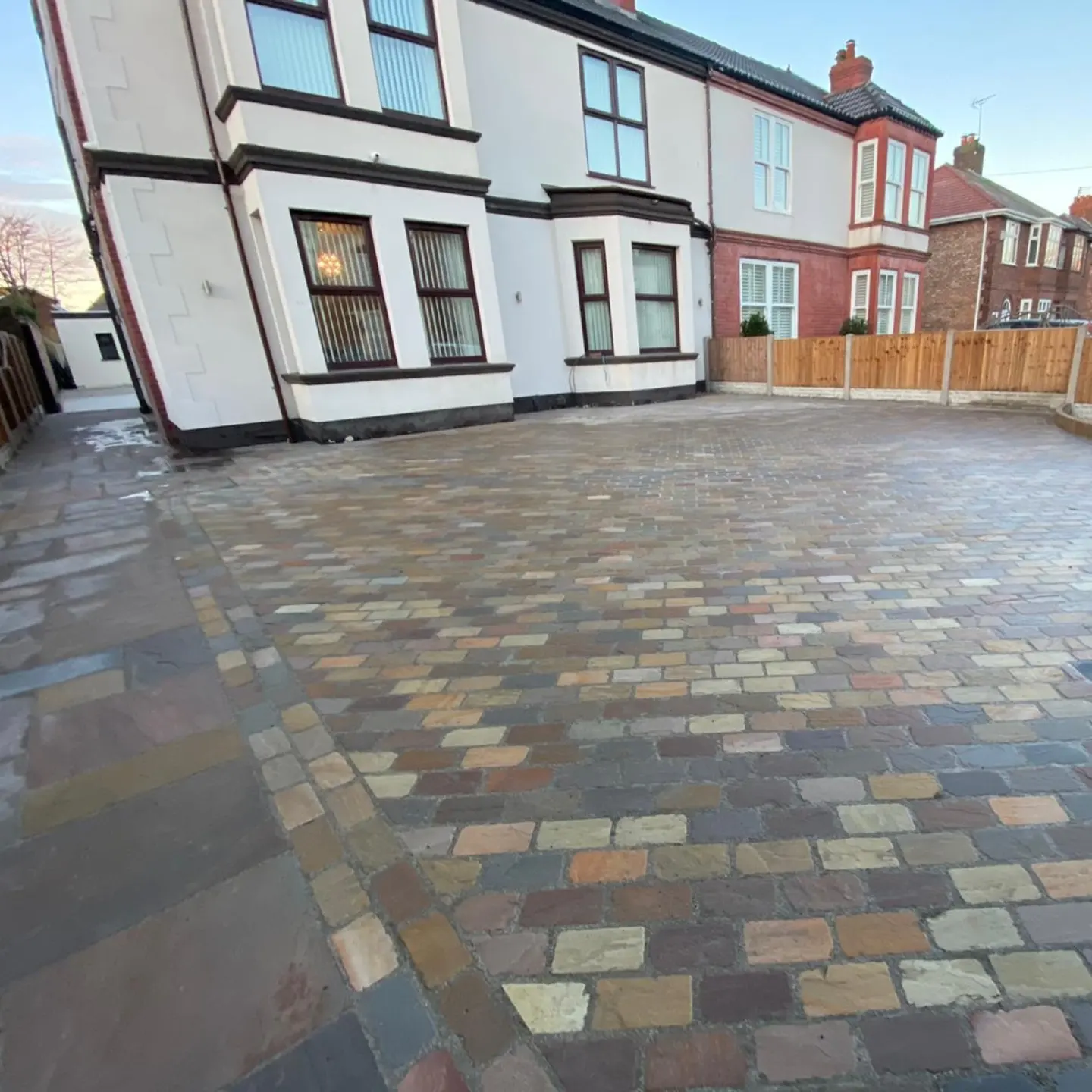 Multi-coloured sandstone cobble driveway in front of a Victorian semi